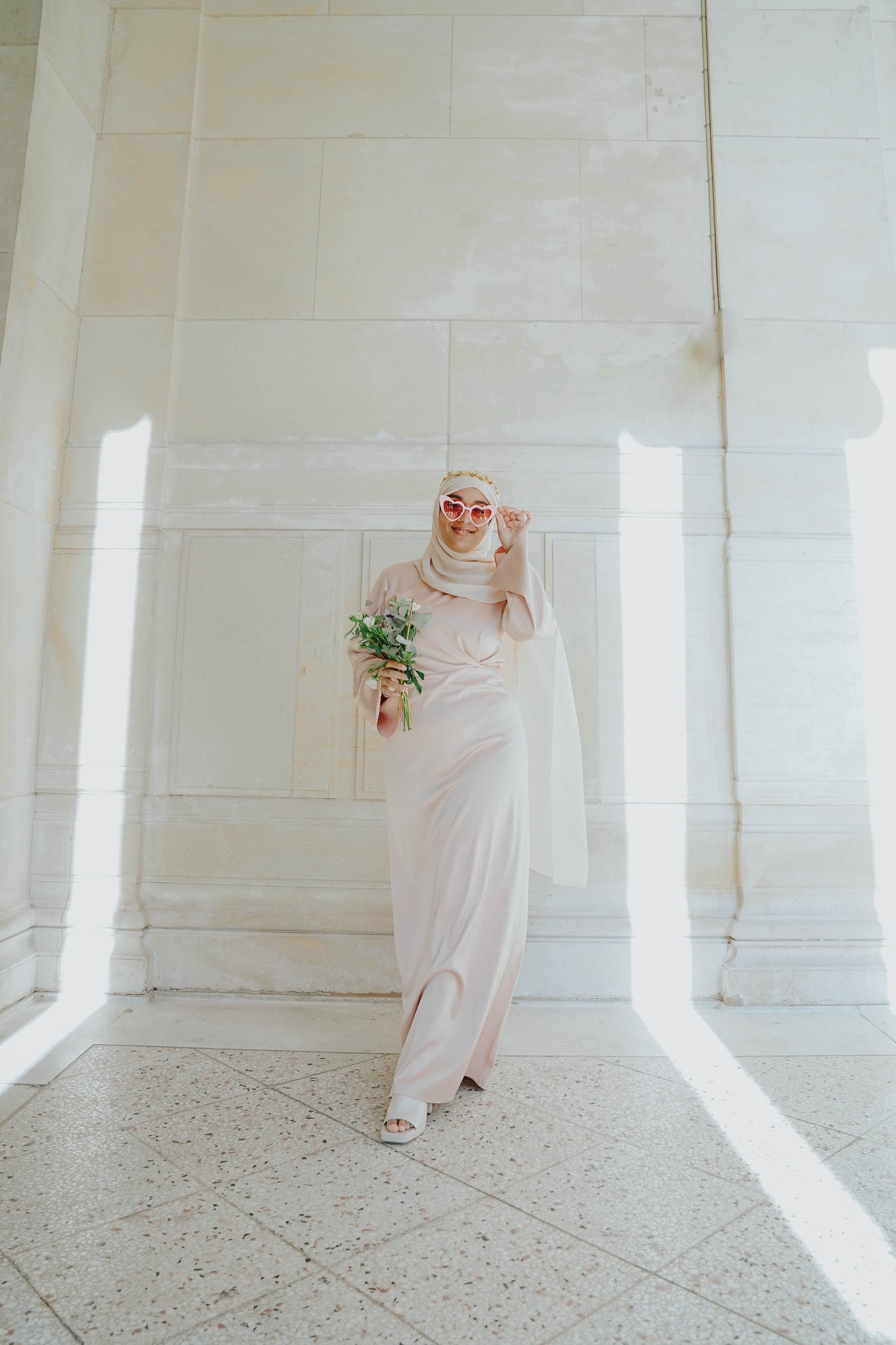 Robe en satin russe couleur nude rosé avec croisé à la taille.  Manches longues évasées
